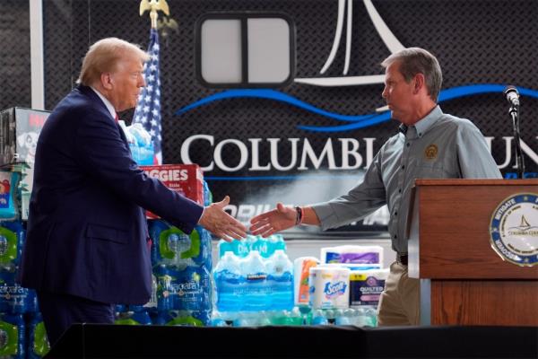 Donald Trump shakes hands with Georgia Gov. Brian Kemp at a temporary relief shelter as he visits areas impacted by Hurricane Helene, Friday, Oct. 4, 2024, in Evans, Ga.